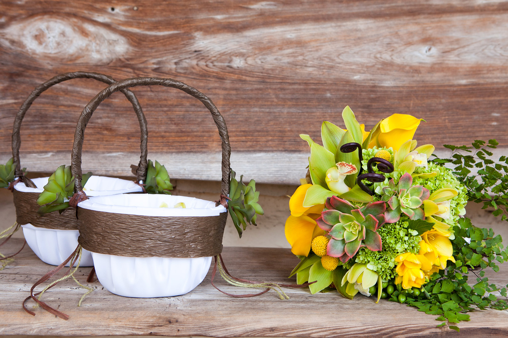 An image of a lovely bright yellow and green succulent bouquet and garden theme flower girl baskets from the Sherman Garden Wedding