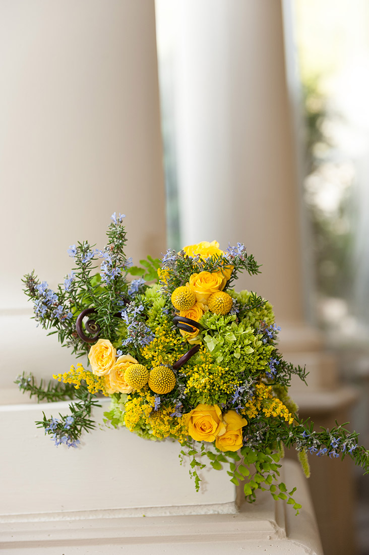 An image of a lovely yellow rose and blue flower bouquet from the Sherman Garden Wedding