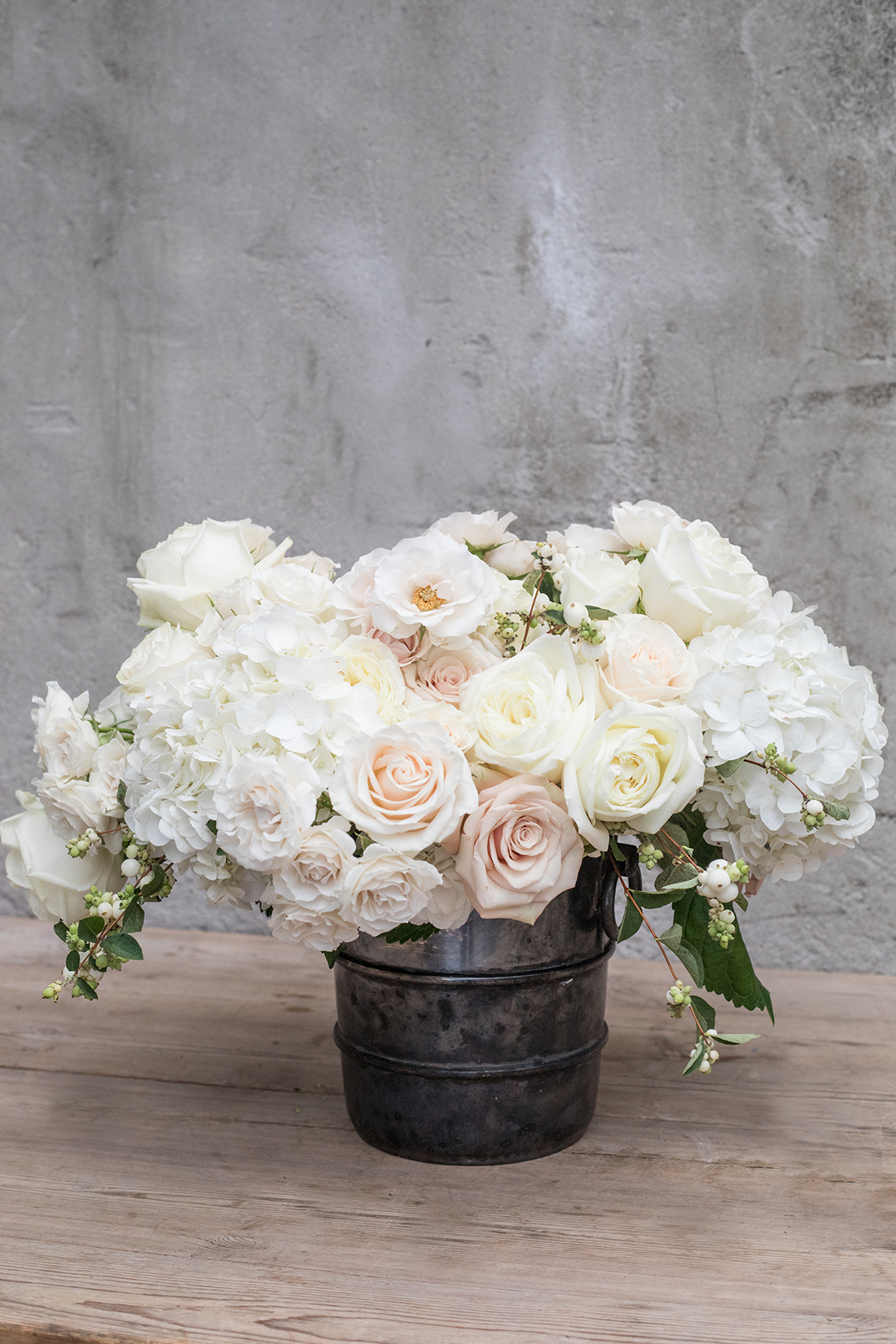 An image of a white rose and hydrangea wedding arrangement