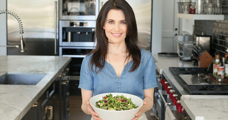 An image of Pamela Salzman holding a garden salad