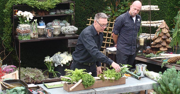 An image of Eric Cortina leading a seminar at Roger's Gardens about a winter celebration