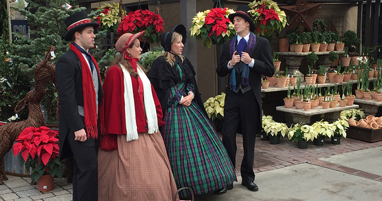 An image of Christmas Carolers singing throughout Roger's Gardens during the Christmas Shopping Season
