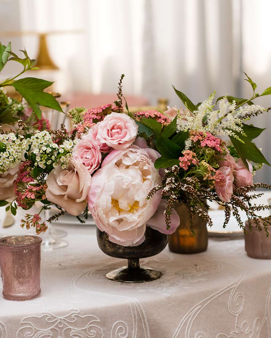 An image of a pink roses and white flowers floral wedding arrangement