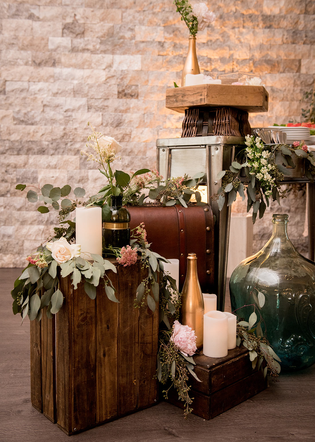 An image of the floral decorations decorating suits cases and vintage items for the Fete Venue Wedding