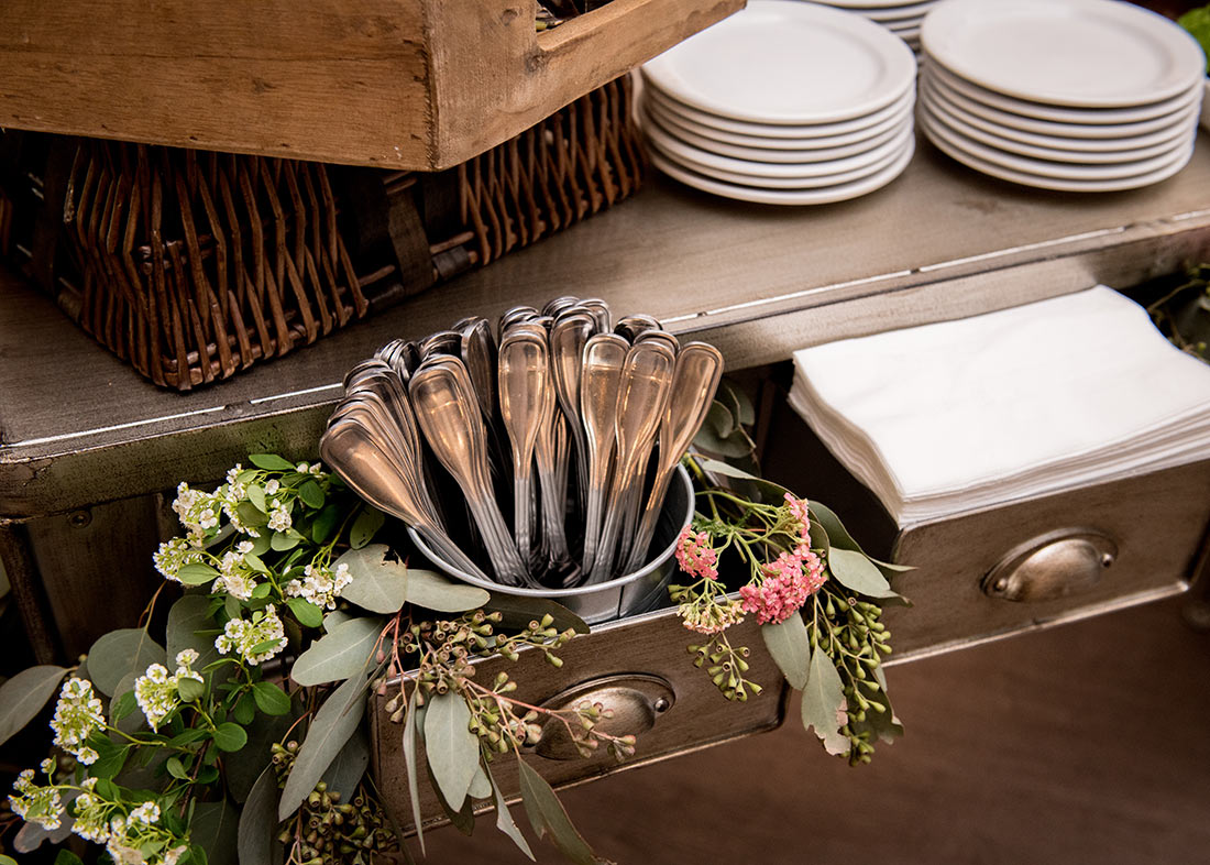 An image of metal drawers decorated with pink and white tiny flowers surrounding silverware