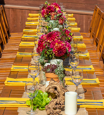 An image of a yellow theme pink red dahlia dining set up